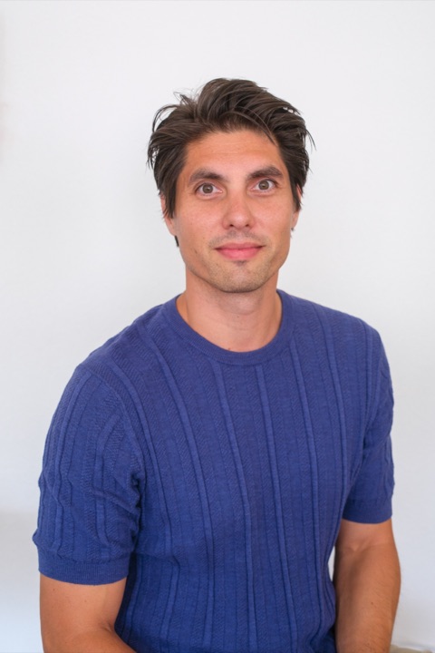 Remco Livain, smiling, in a blue knit shirt